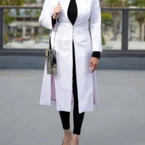Woman in white coat and black outfit.