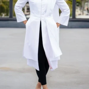 Person wearing white coat and black pants.